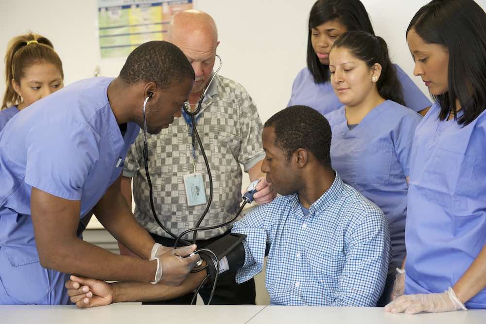 Career Academy student taking blood pressure