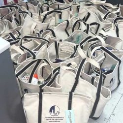 Tote bags containing care packages for asylees