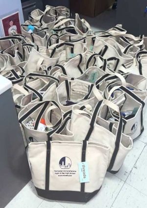 Tote bags containing care packages for asylees