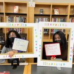 Students posing with "I Applied" photo frames