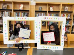 Students posing with "I Applied" photo frames
