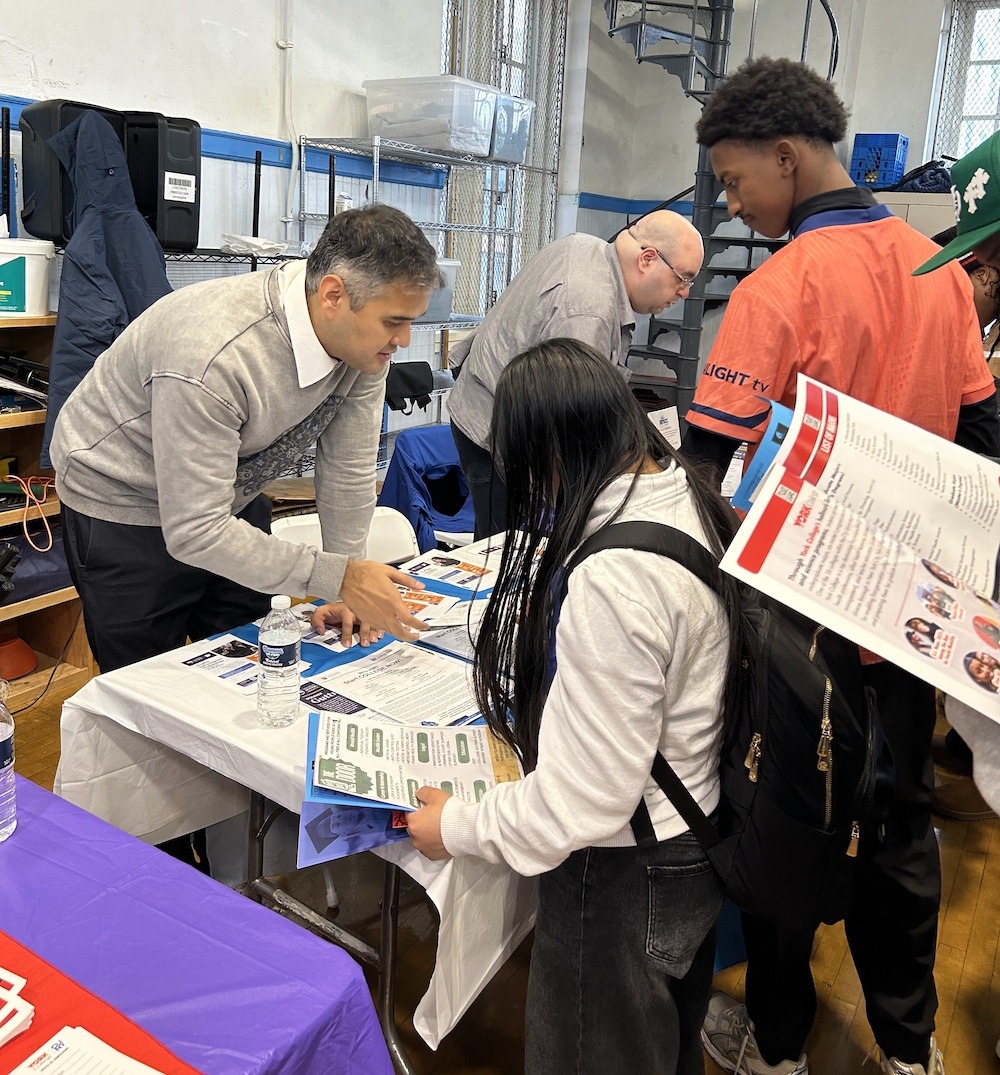 Program rep speaking with student at Manhattan Comprehensive's College & Career Fair