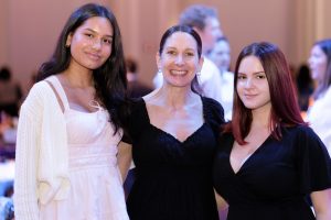 Rachel Potts, Director of the AtomicMind Foundation, at the 2024 CYD Spelling Bee with AtomicMind scholarship recipients Elizabeth and Sheyla