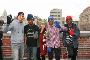 Students wearing colorful hats and gloves