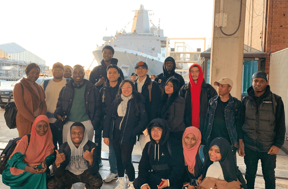 Students in front of USS New York